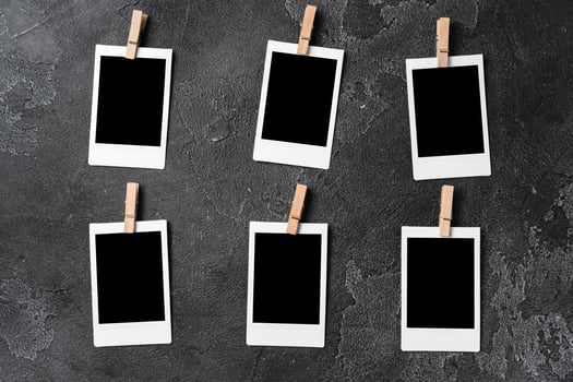 Paper photo frames with blank space on gray textured background