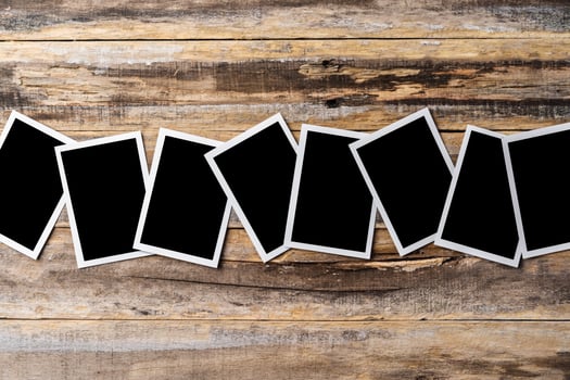 Blank photo frames for your photos on wooden background