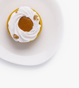 Elegant pumpkin tart with cream on white plate photo