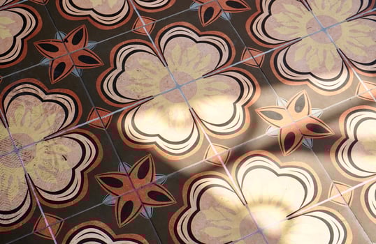 Abstract decorative brown and yellow floor tile floral pattern design isolated on horizontal ratio sun light and shadow shade background. photo