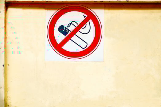 Prohibition sign no smoking on a dirty scratched wall photo