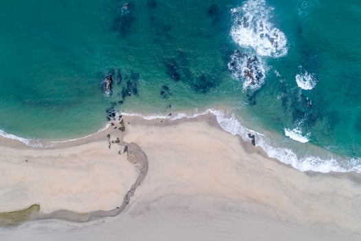 Drone aerial view of a beach with a small river photo