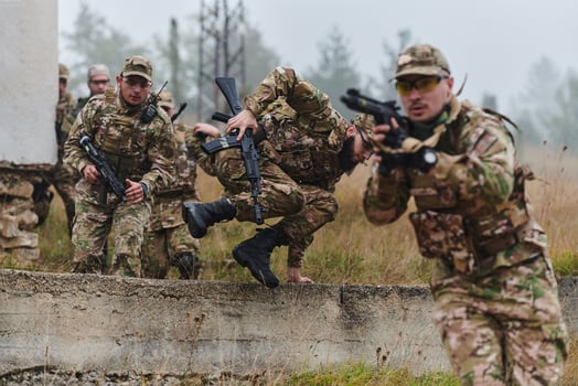 A highly trained elite military unit, clad in camouflage, skillfully navigates through perilous forest terrain, overcoming obstacles and executing a precise and covert mission photo