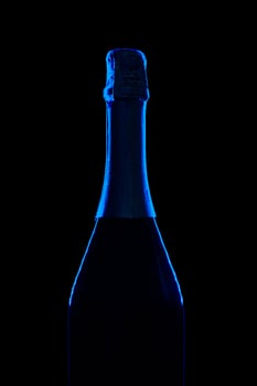 Champagne bottle on dark black background close up photo