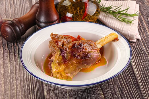 Baked lamb shank with vegetables photo