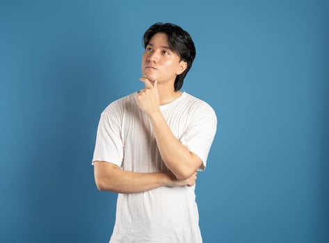 Portrait of asian man posing on blue background photo