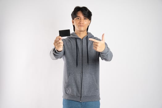 Portrait of asian man wearing hoodie posing on white background photo