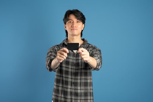Portrait of Asian male student posing on blue background photo