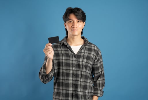 Portrait of Asian male student posing on blue background photo