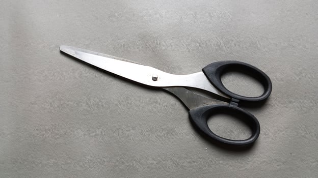 Scissors on a gray background. photo
