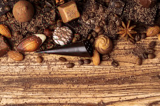 chocolate, cocoa, nuts and spices on wooden background photo
