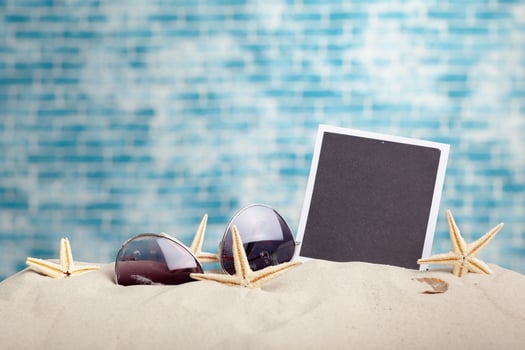 photo frames on the beach with seashells around