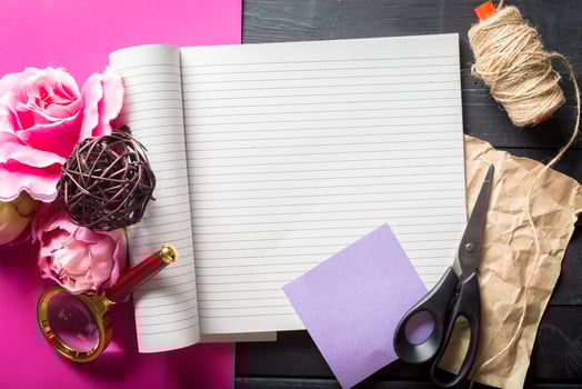 flowers and a notebook on wooden background photo