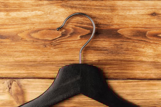 Composition with clothes hangers on wooden background. photo