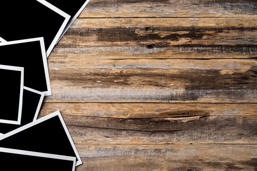 Blank photo frames for your photos on wooden background
