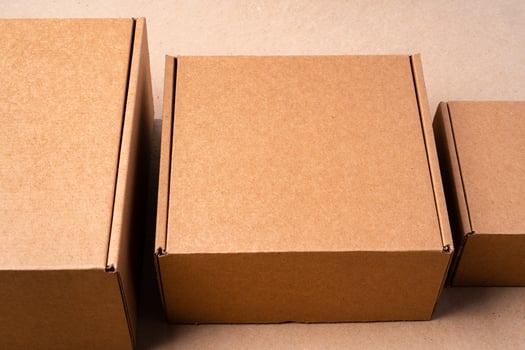 Cardboard box on beige background in studio photo