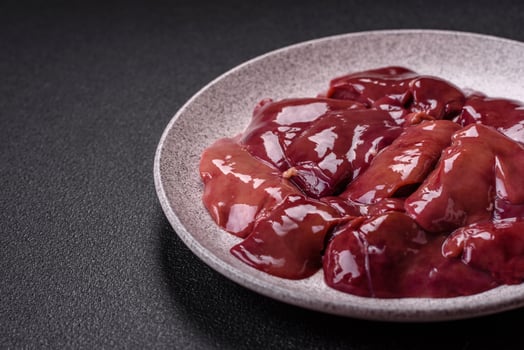 Fresh raw chicken or beef liver with salt, spices and herbs photo