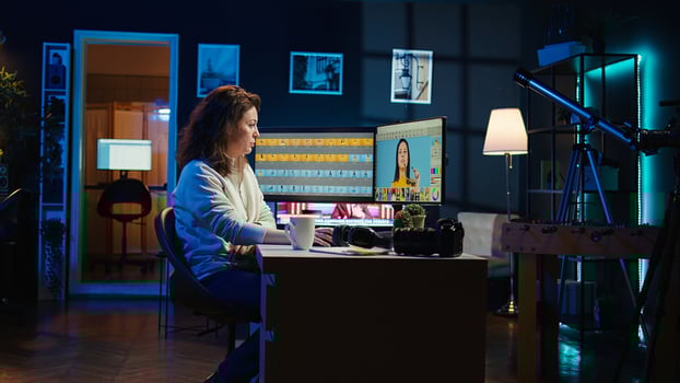 Photographer using advanced photo editing software on monitor. Photo editor utilizing specialized photographs retouching application to make adjustments on computer screen, camera B
