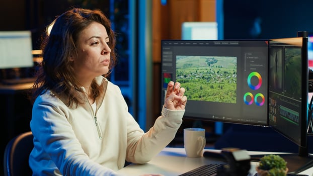 editor working for production company checking stills on camera gallery before inputting music, dialogues, graphics and effects over raw footage, editing clips for final project, camera A photo