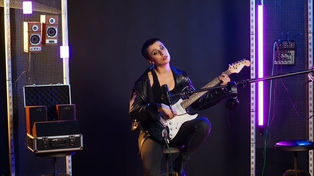Confident female singer delivers a powerful vocal performance in a live show. Edgy heavy metal artist with rock star vibes performing a live song, iconic artist singing alternative music. Camera B. photo