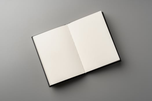 Blank notepad on gray background studio shot photo