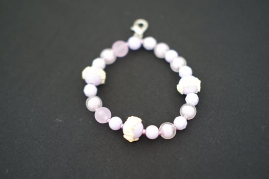 A beaded bracelet on a black surface. photo