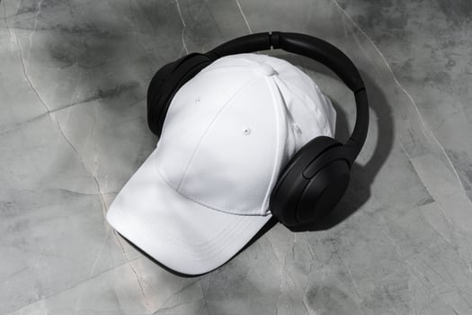 Baseball cap with black headphones on dark background photo
