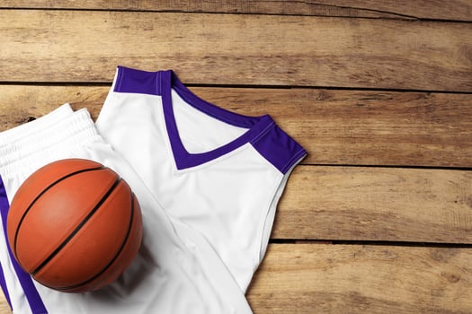 Basketball uniform on wooden background top view photo