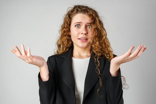 Young Curly Clueless Woman Holding Out Hands photo