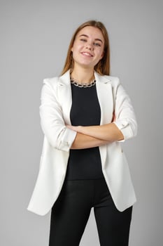 Woman in Black Top and White Jacket Posing in Studio photo