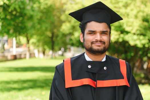 education, graduation and people concept - happy Indian Male graduate student photo