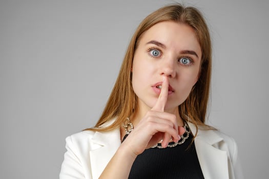 Woman With a Finger on Her Lips Hush Sign photo