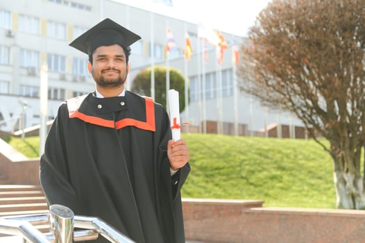 education, graduation and people concept - happy Indian Male graduate student photo