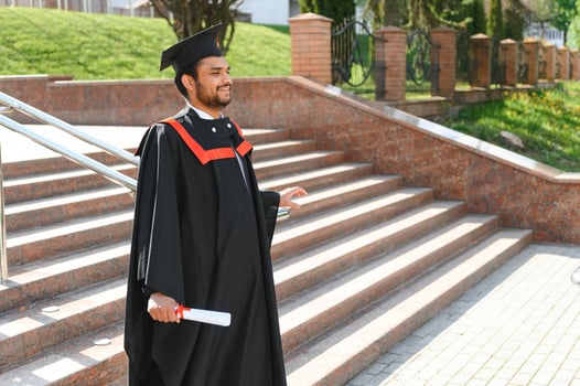 Portrait of happy man, graduation or student in university campus photo