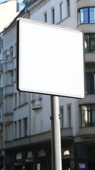 A blank road sign with a white background, mounted on a street post, isolated for mockup photo