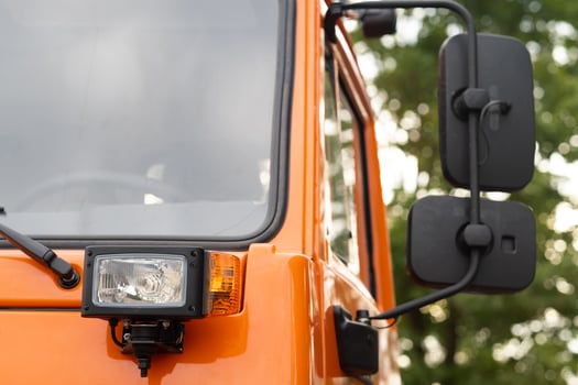 Close-up of the cab of an orange-colored truck photo