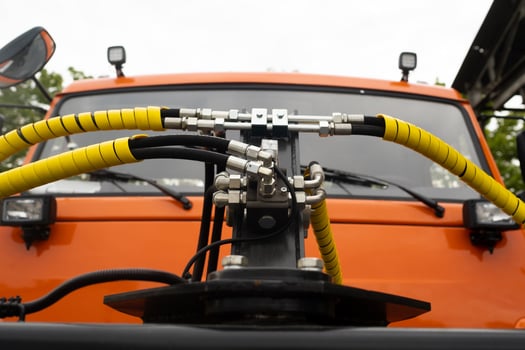 Close-up of an assembly with hydraulic pipes and couplings on a truck photo
