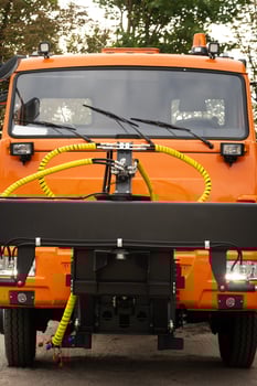 Close-up of the cab of an orange-colored truck photo