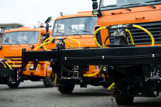 New Trucks standing in a row on an orange-colored street photo