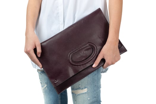 Woman holding a handbag isolated on white background photo