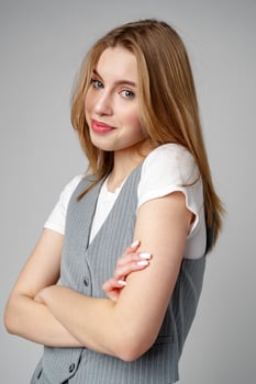 Joyful Young Blonde Woman Smiling against gray background photo