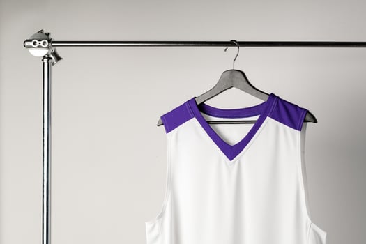 White basketball jersey hanging against white background photo