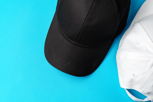 Baseball caps on blue background studio shot photo