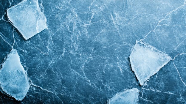 Delicate pattern of powdery light grey and silver pigments spread thinly on a deep ice blue background photo