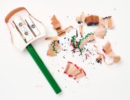 Green wooden pencil and sharpener on white background, top view photo
