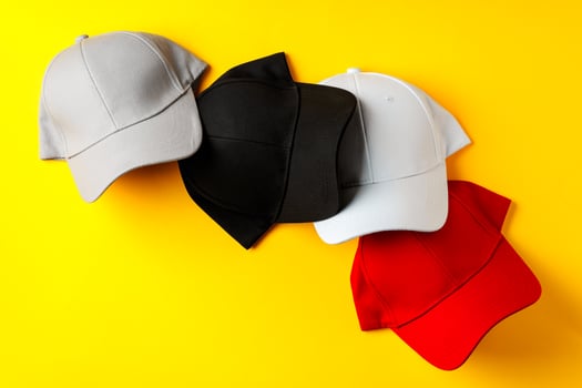 Baseball hat against yellow background in studio photo