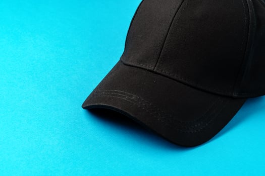 Baseball caps on blue background studio shot photo