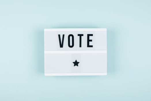 The word VOTE written on lightbox on background. Election concept photo