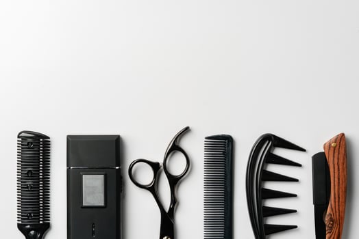 Set of barber tools for haircut on gray background flat lay photo