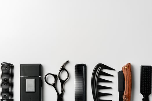 Set of barber tools for haircut on gray background flat lay photo